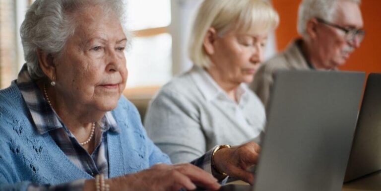 Three Seniors Using Laptops in an Independent Living Facility