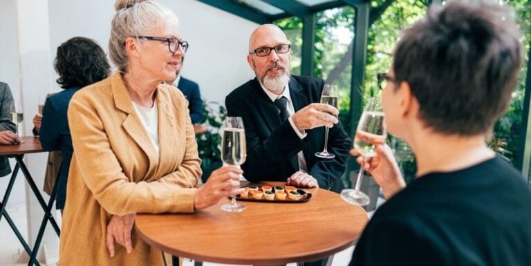 Group of Seniors Enjoying Champagne and Snacks at Independent Living Facility