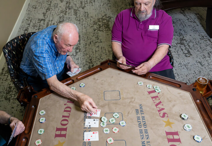 Senior Residents Playing Poker in Independent Living Facility Senior Residents Playing Poker in Independent Living Facility