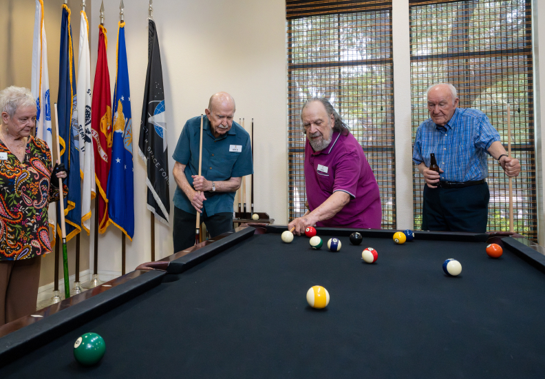 Group of Seniors Enjoying a Game of Pool at an Independent Living Facility Recreation Room Group of Seniors Enjoying a Game of Pool at an Independent Living Facility Recreation Room