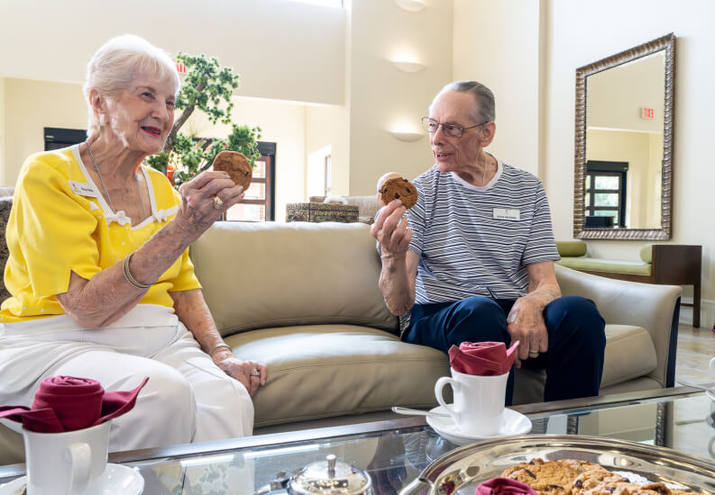 Senior Couple Enjoying Their Cookies at Independent Living Facility Senior Couple Enjoying Their Cookies at Independent Living Facility