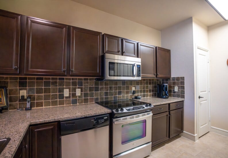 Full Kitchen With Appliances and Cabinet Storage in Independent Living Facility Full Kitchen With Appliances and Cabinet Storage in Independent Living Facility