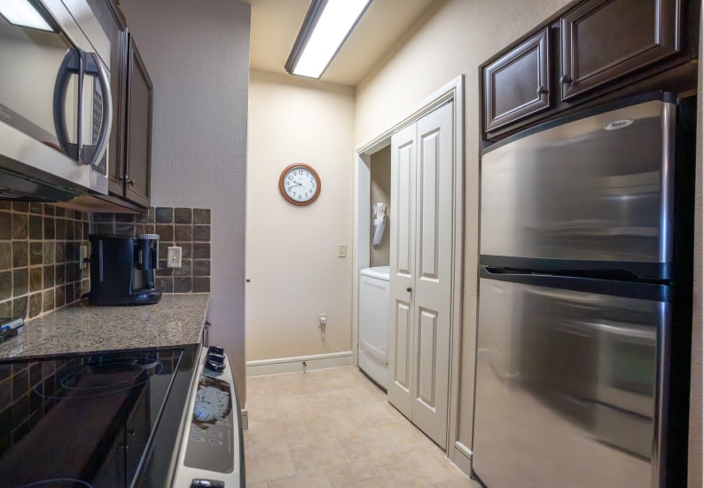 Kitchen Area With Appliances and Laundry Access in Independent Living Facility Kitchen Area With Appliances and Laundry Access in Independent Living Facility