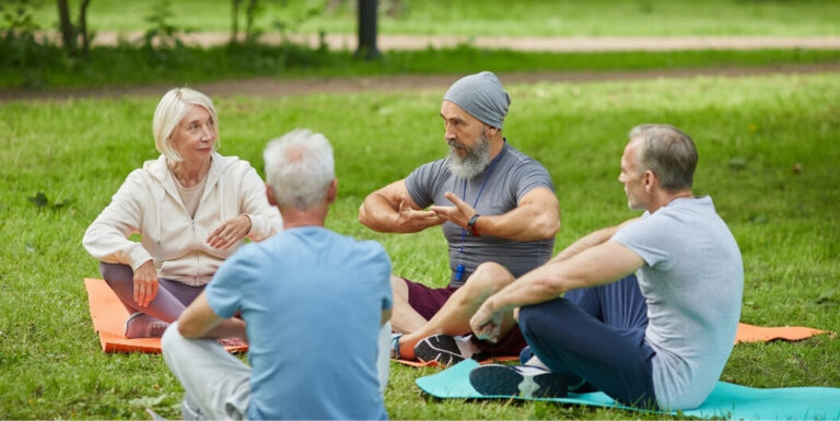 Elderly Group Attending Outdoor Wellness Class at Independent Living Facility